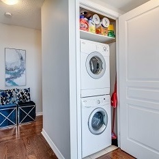 laundry room with wood floors
