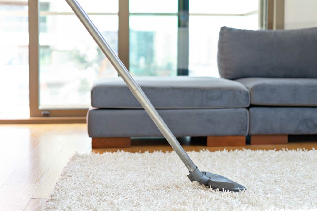 cleaning carpet with vacuum cleaner