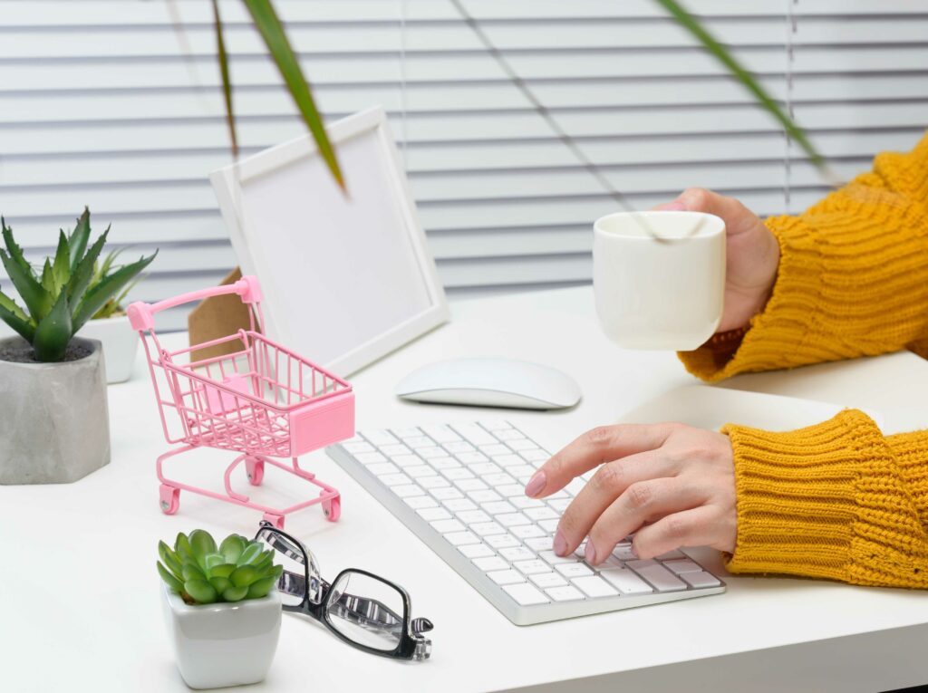 women in sweater scrolling online shopping