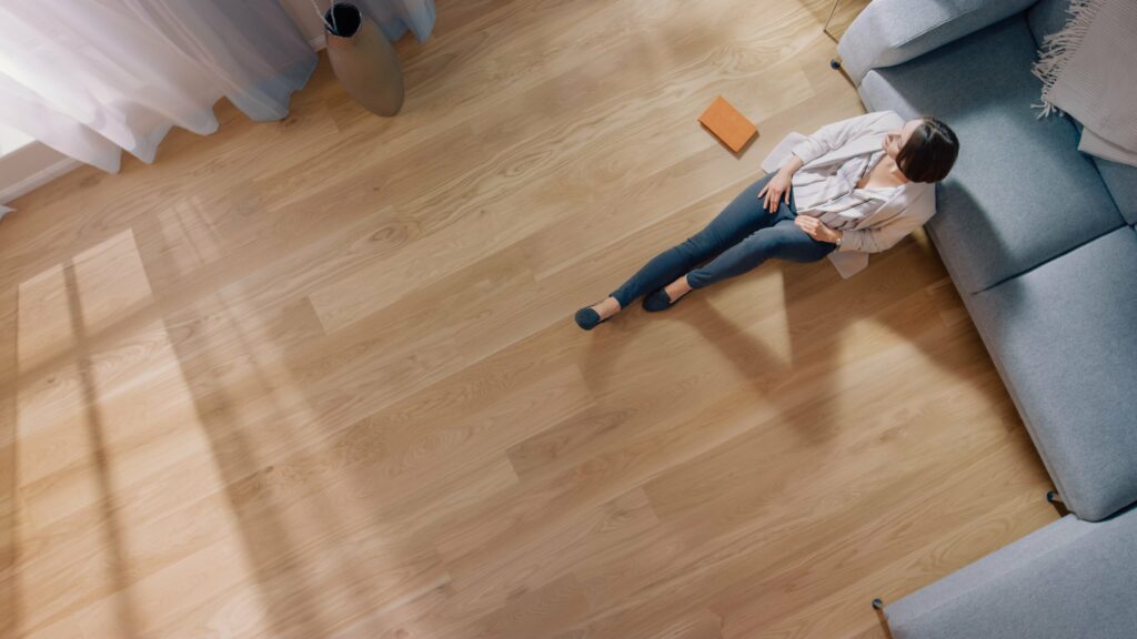 Woman sitting on wood floors