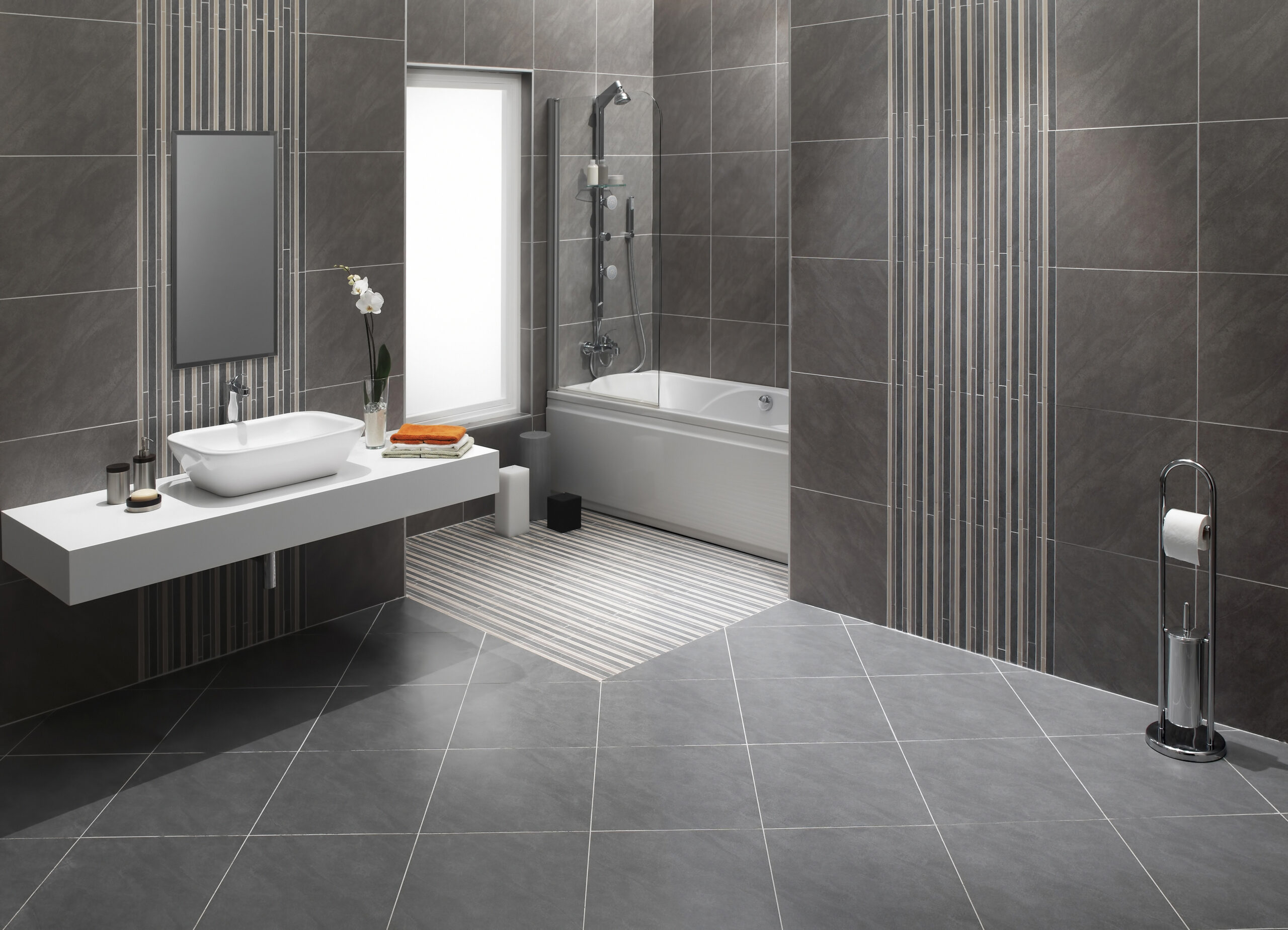 bathroom with grey tile flooring and walls